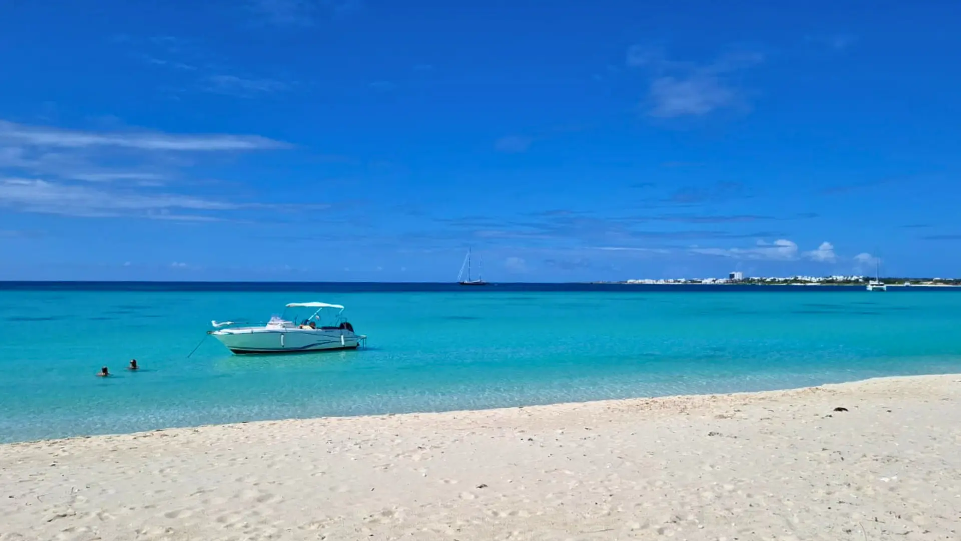 Private boat anchored on Anguilla beach calm Caribbean water