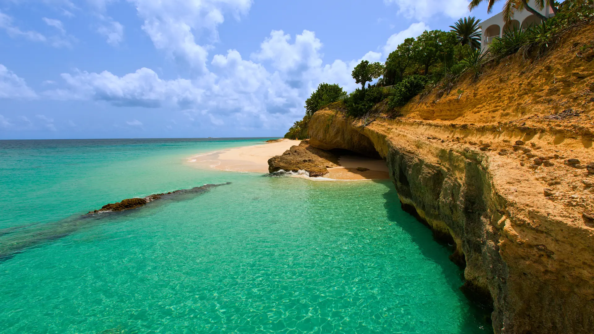 Private boat anchored in Anguilla bay with clear Caribbean water