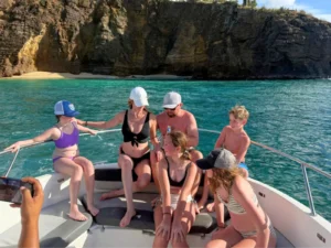 Family with children relaxing on a private boat charter in St Maarten near a quiet beach