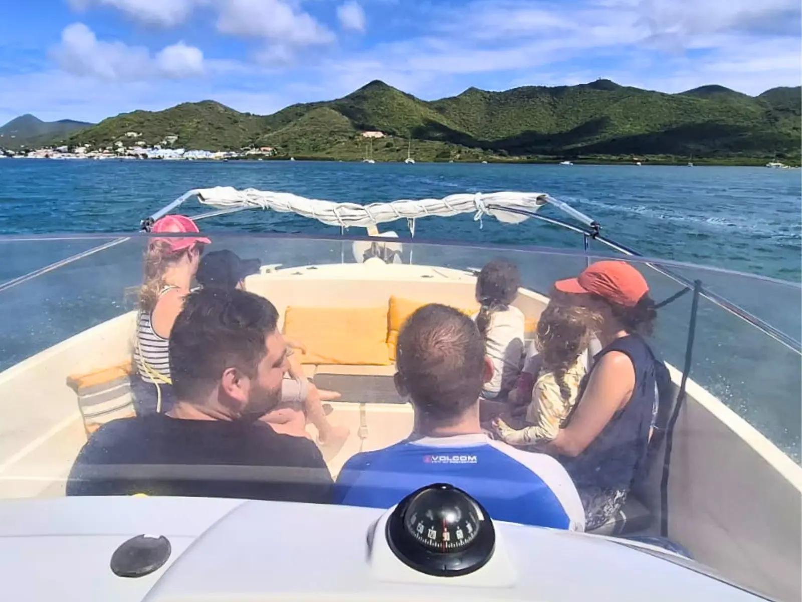 Family enjoying a private boat charter in St Maarten while cruising along the coastline