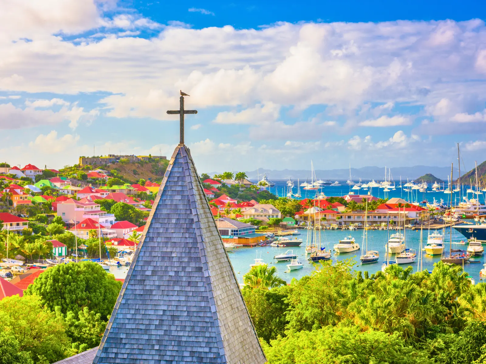 View over Gustavia harbour in St Barts with yachts and red-roofed buildings