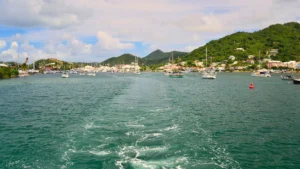 Boat leaving Simpson Bay Lagoon with mountains and marina in St Maarten
