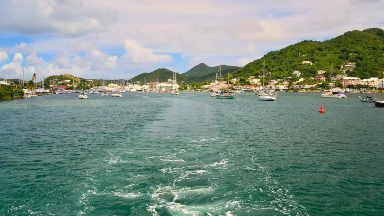 Boat leaving Simpson Bay Lagoon with mountains and marina in St Maarten