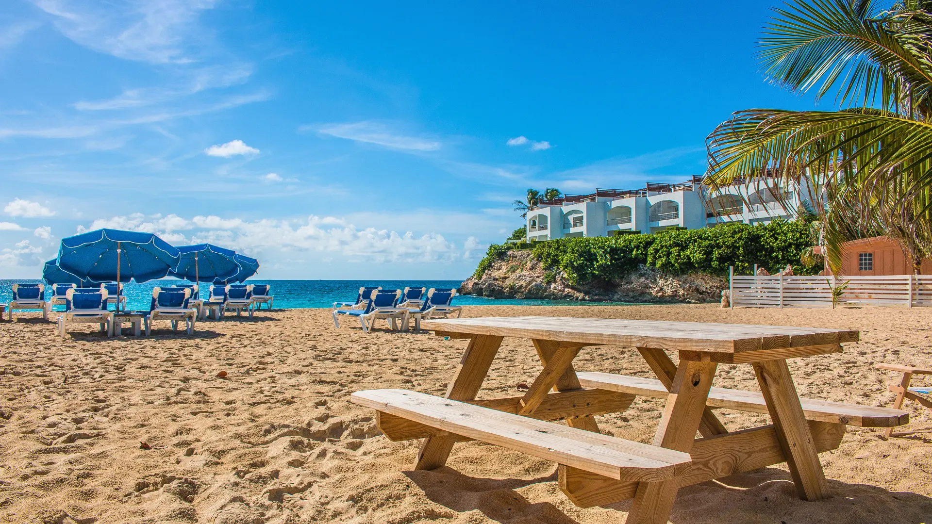 Beach with umbrellas and beachfront villa in Simpson Bay St Maarten