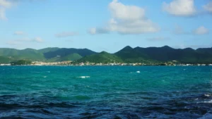 St Maarten coastline viewed from the sea with mountains and turquoise water