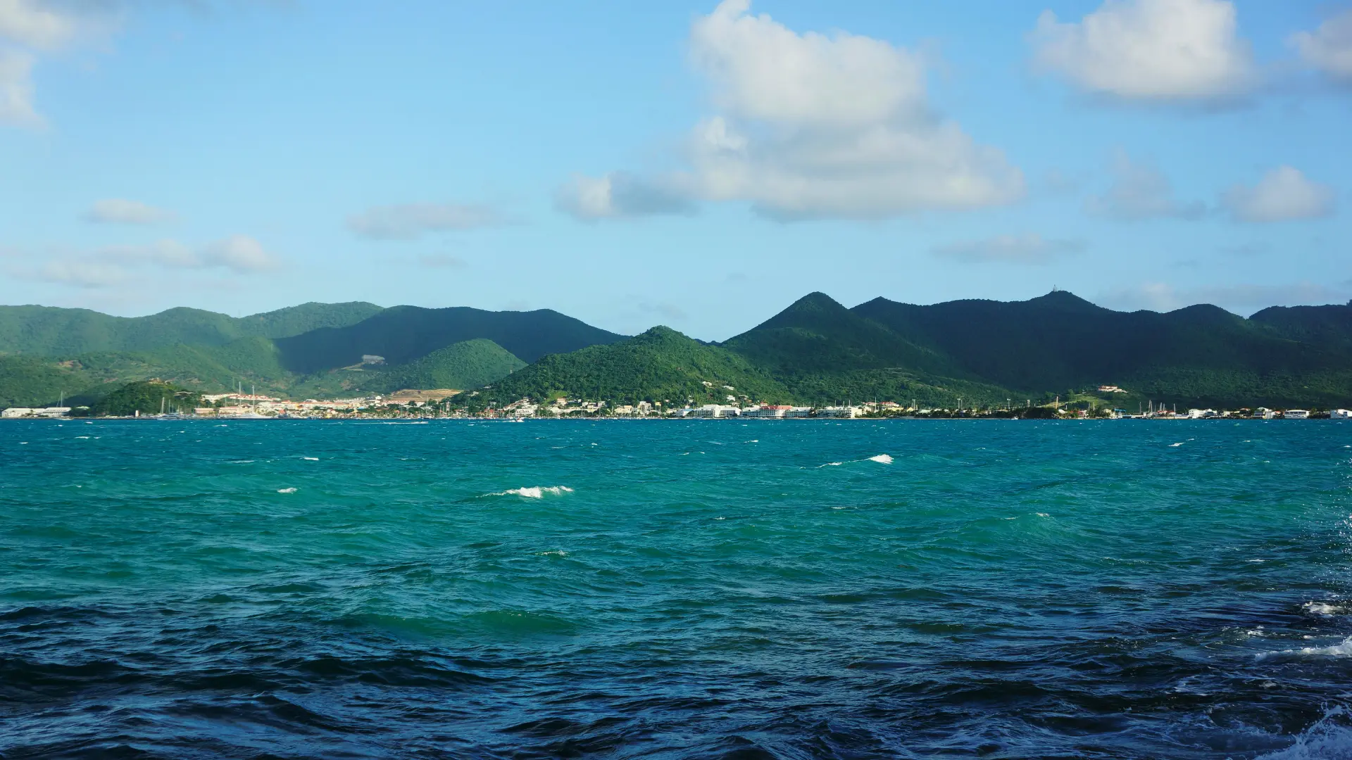 St Maarten coastline viewed from the sea with mountains and turquoise water
