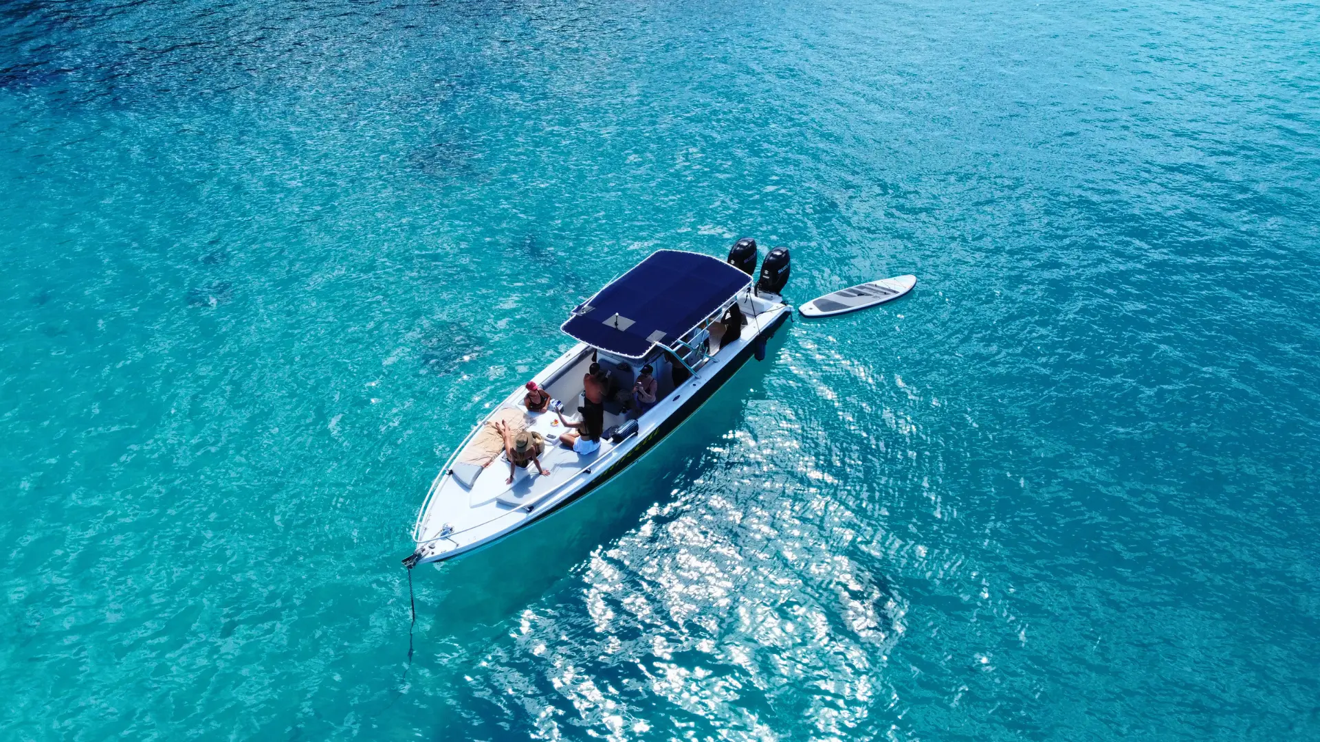 Private boat charter in St Maarten with guests relaxing onboard in clear turquoise water