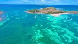 Aerial view of boats anchored near Pinel island with turquoise water on a St Maarten boat charter