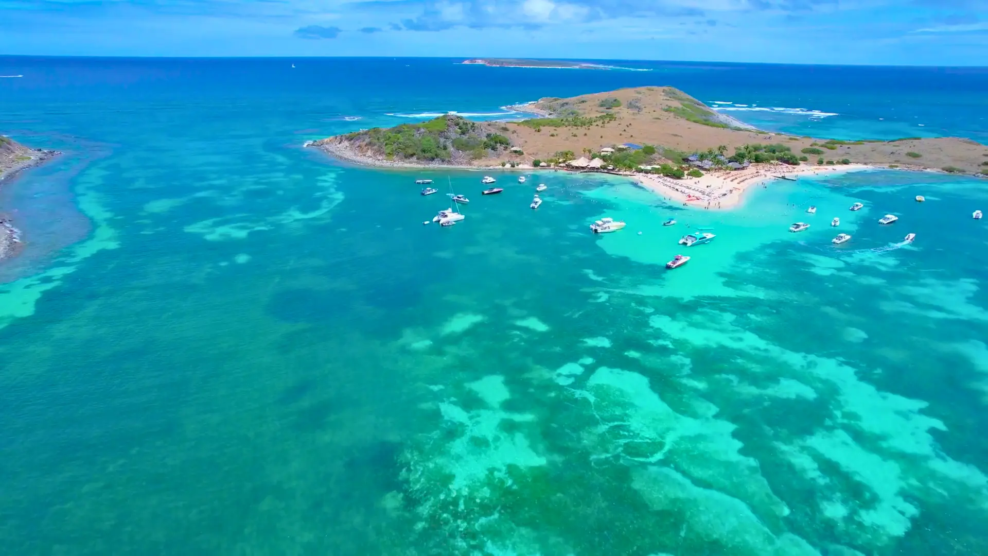 Aerial view of boats anchored near Pinel island with turquoise water on a St Maarten boat charter