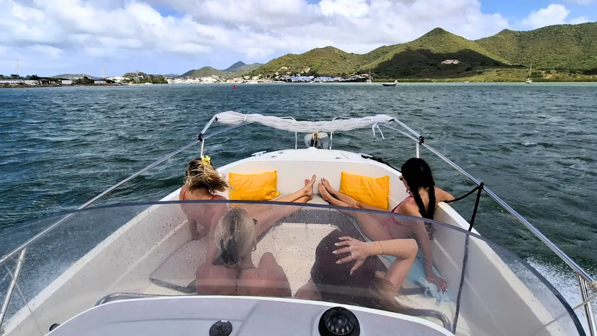 Private boat cruising in St Maarten lagoon with mountains in the background