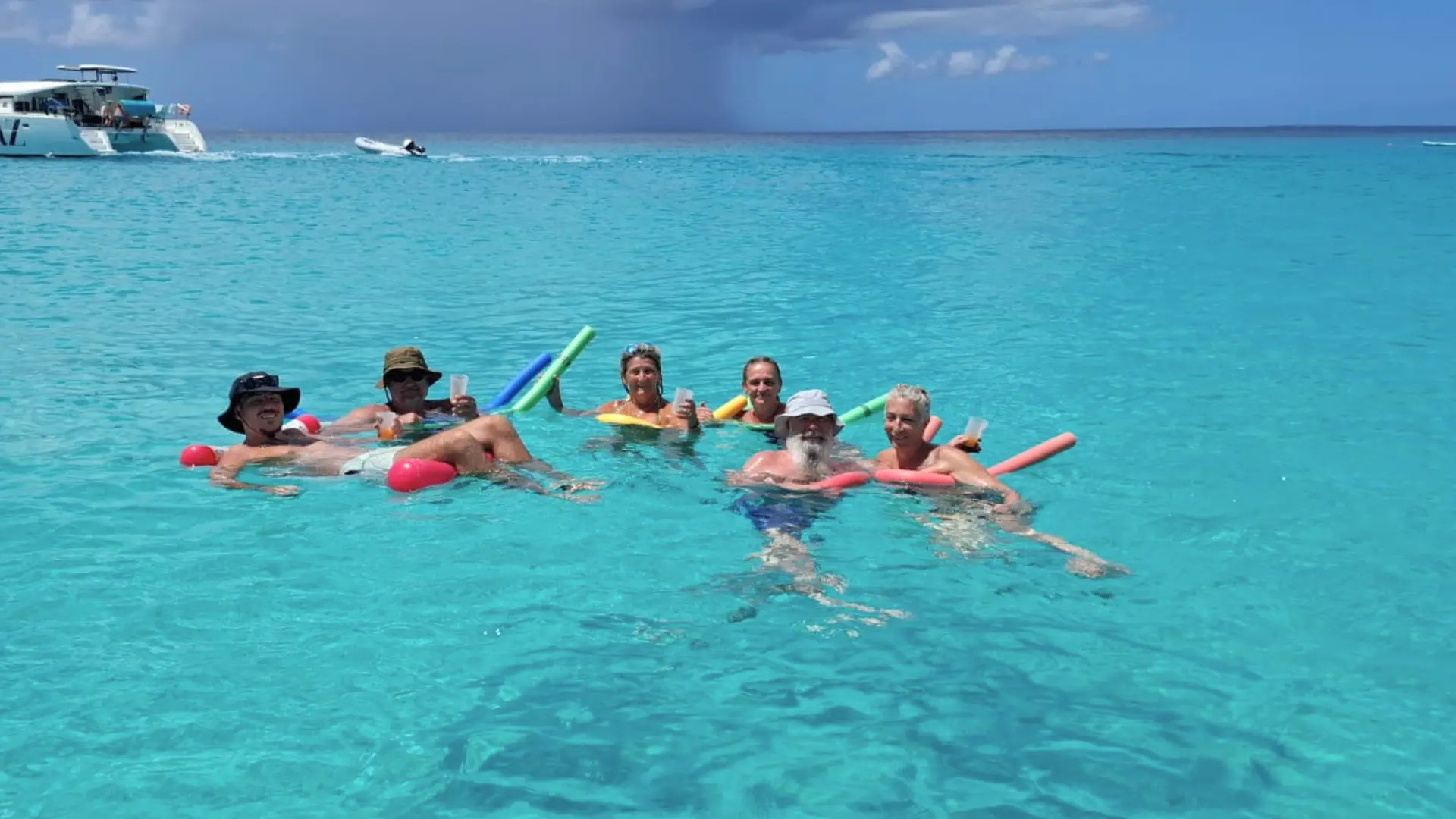 Group relaxing in the water during a private boat charter in St Maarten
