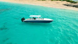 Private motorboat anchored near a quiet beach in St Maarten with crystal clear water