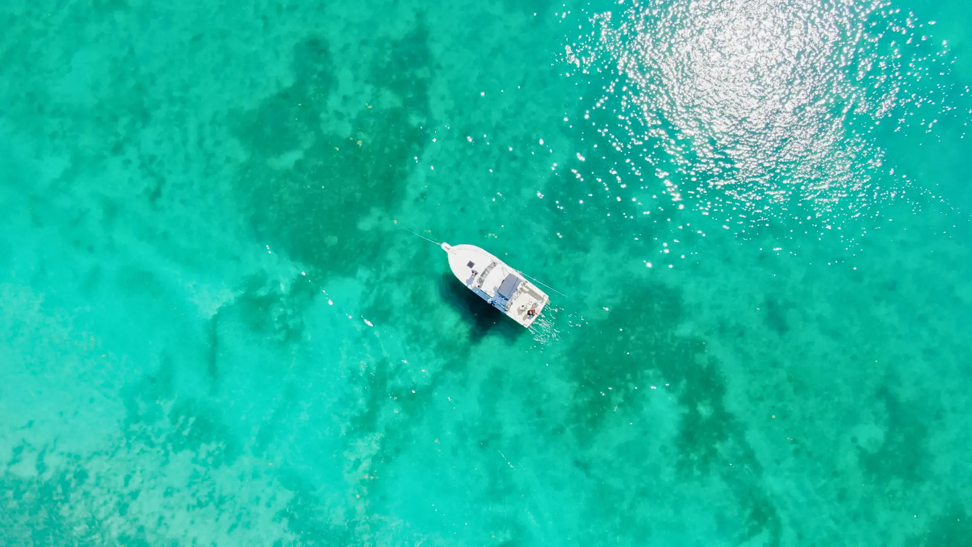 Small boat anchored in clear shallow water during a St Maarten private boat trip