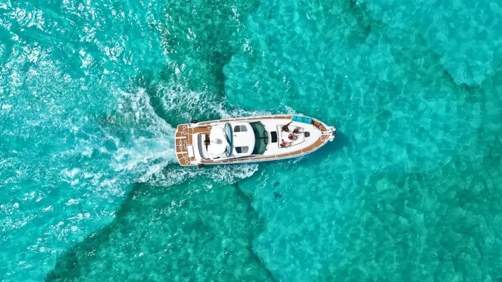 Private powerboat cruising across turquoise Caribbean waters
