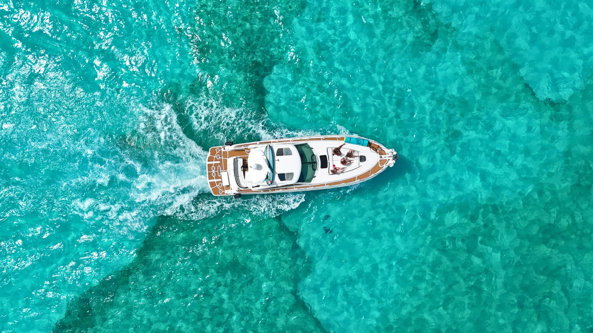 Aerial view of a private yacht cruising over turquoise water in St Maarten