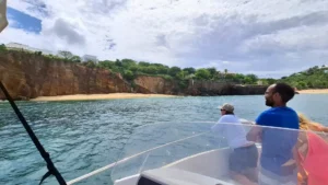 Guests on a private boat exploring cliffs and hidden beach in St Martin