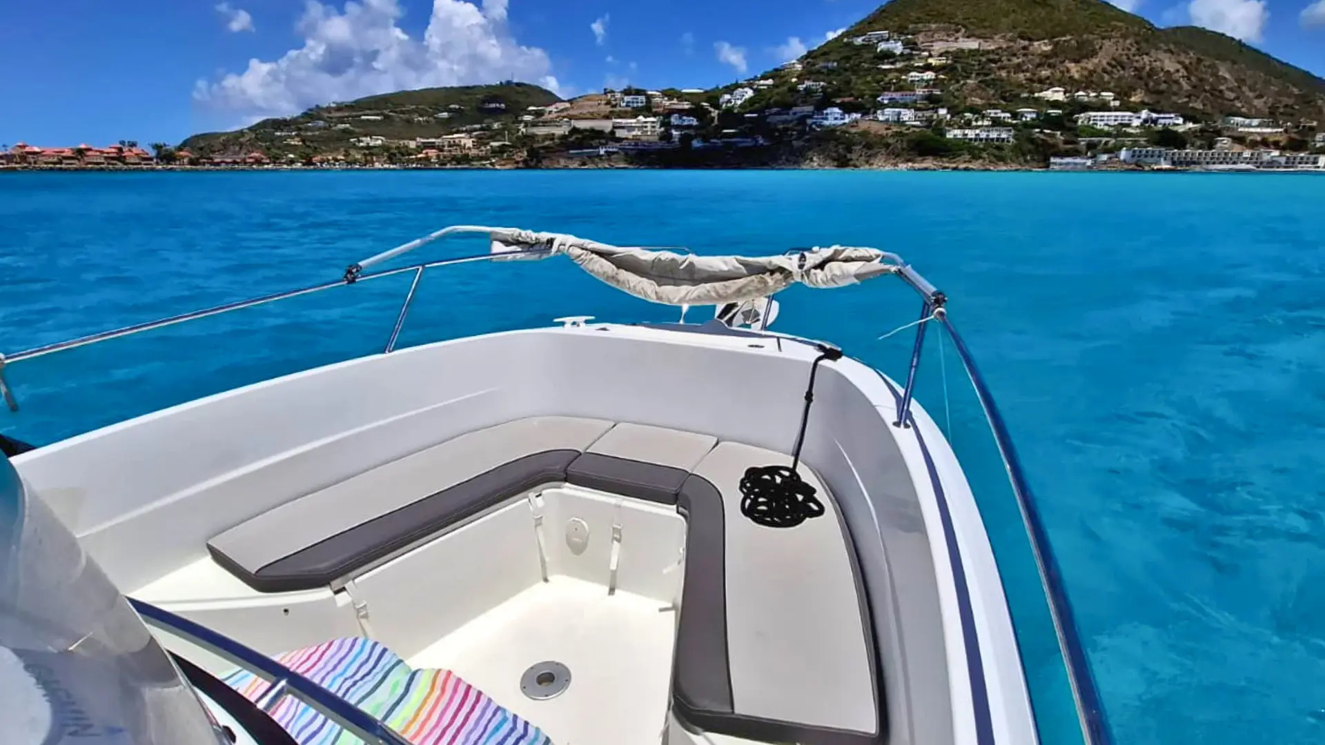 View from a private boat approaching the St Maarten coastline with clear blue water