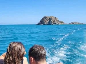A couple leaving Creole Rock astern on a private boat charter in St Martin