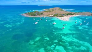 Private boat charter at Pinel Island near St Martin with boats anchored in clear shallow water
