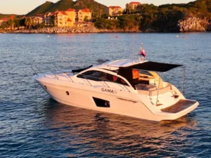 Private motor yacht anchored at sunset near coastline in St Maarten with warm evening light