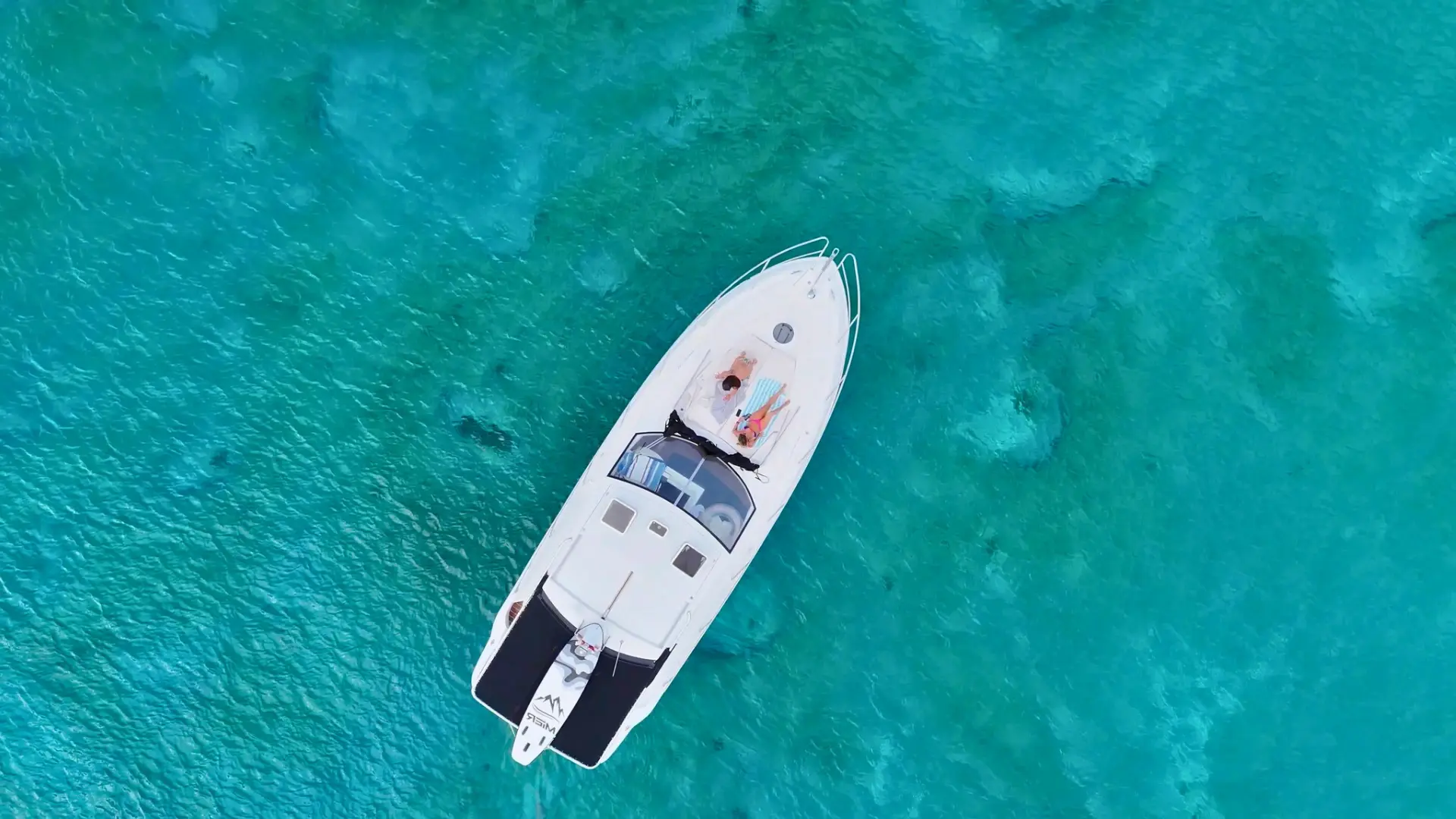 aerial view of premium private yacht anchored in turquoise water st maarten with couple relaxing on bow