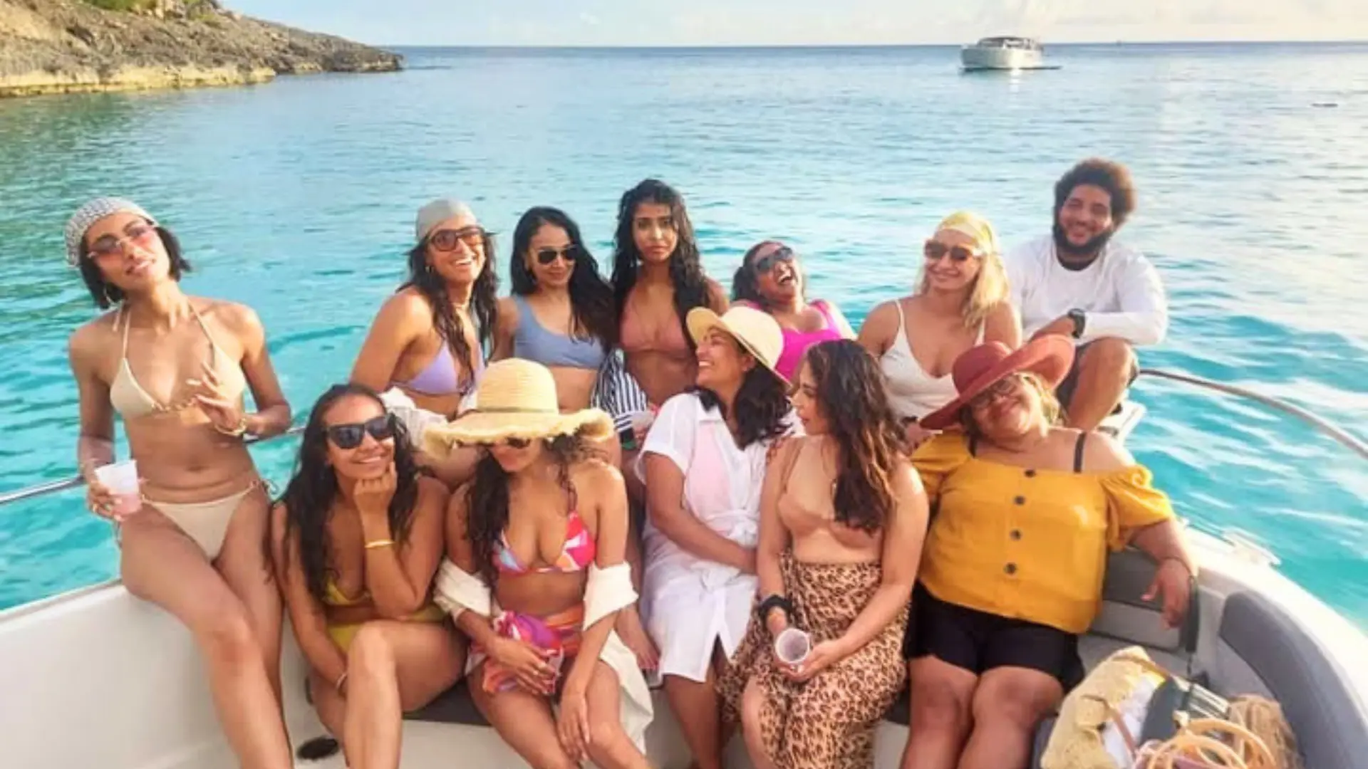 A happy group of friends at the bow on a private boat charter in St Maarten