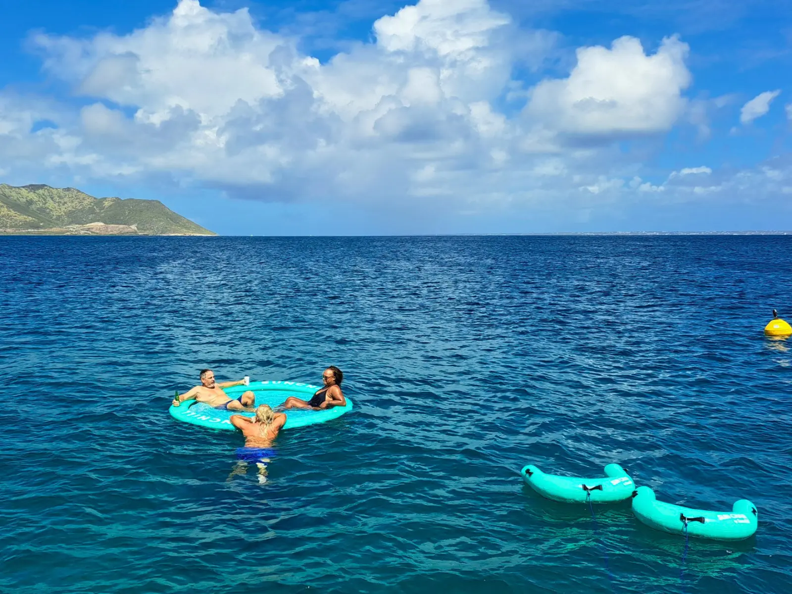 Guests enjoying floating water mats during a private Anguilla charter